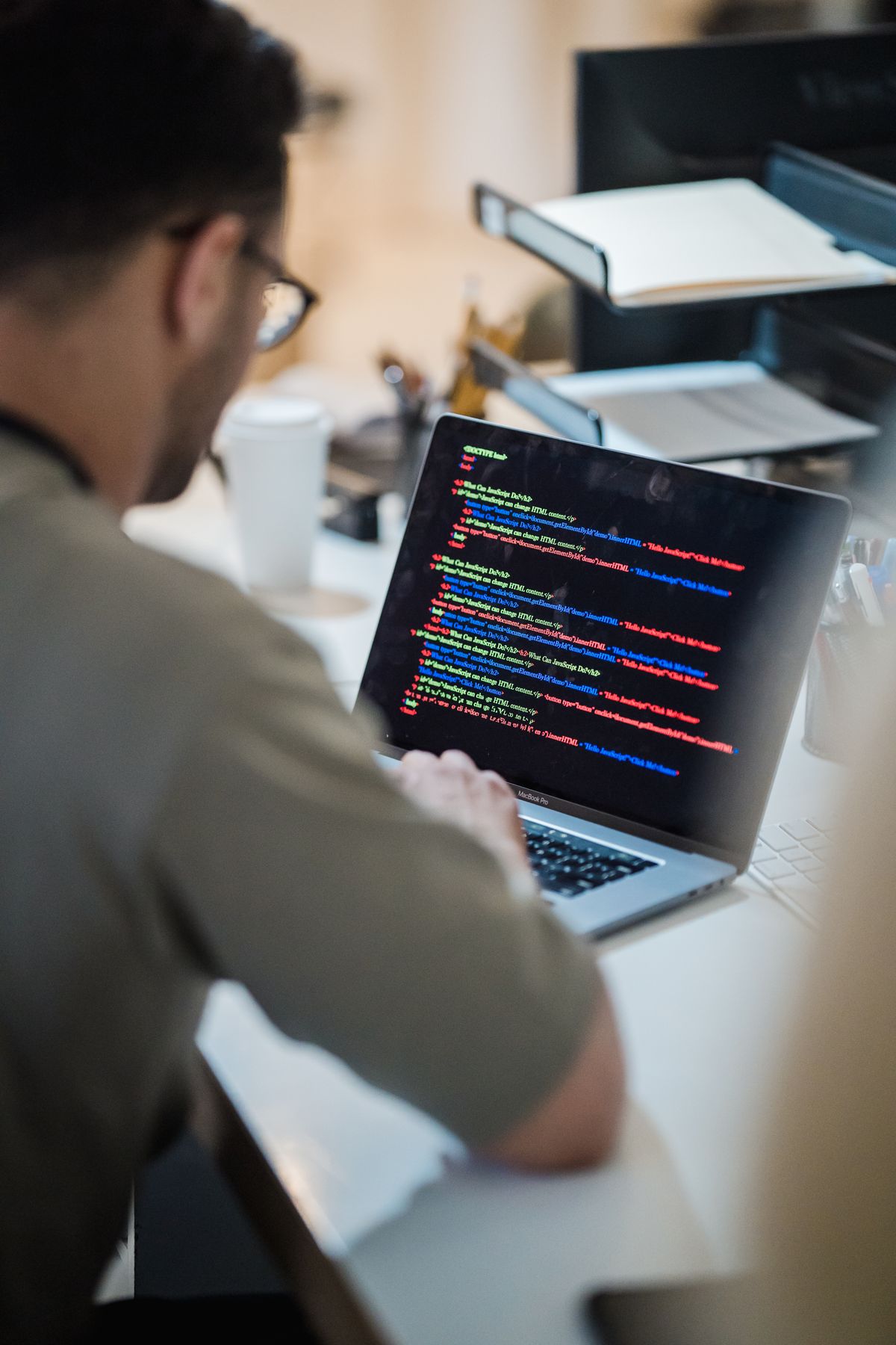 A developer building a full-stack application on a multi-monitor setup