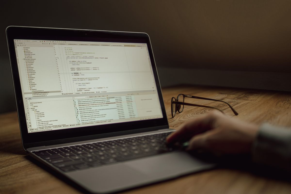 A modern IT workspace with developers and data dashboards